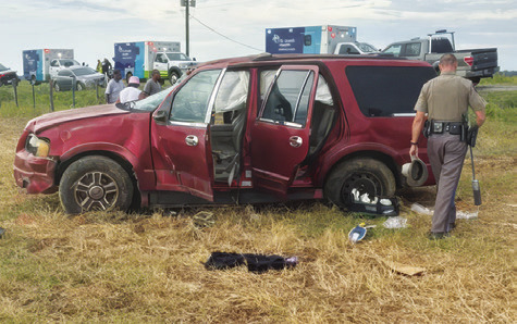 A DPS TROOPER investigates at the accident scene on Saturday.