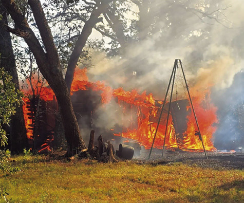 THE FIRE BURNS this building on Sunday off County Road 331. Photo courtesy of Caldwell Volunteer Fire Department