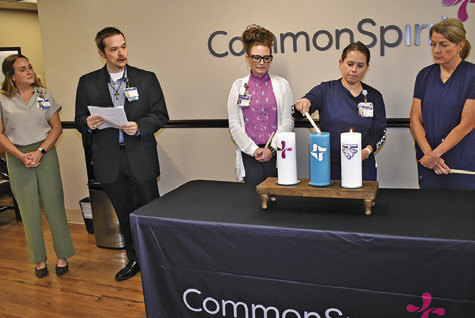 CANDLES ARE LIT at the blessing ceremony at CommonSpirit St. Joseph Hospital -- Burleson County on Monday. Pictured from left are Erin Marietta, Chaplain Scott Floyd, Jo Johnson, Erin Gaas and Heather Page. Local leaders and hospital staff also attended. Tribune photo by Roy Sanders