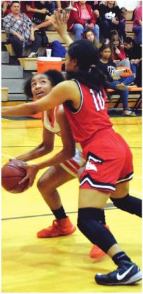 SOMERVILLE FRESHMAN Ra’Maya Carter looks to shoot the ball over a Burton defender during Friday’s Lady Yegua district win.