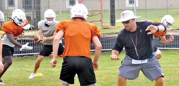 NEW CALDWELL HEAD COACH Matt Langley instructs his players during this Friday workout at the high school. The Hornets will scrimmage Waco Robinson this Friday, and they open their season at home on Aug. 30 against Edna. -- Tribune photo by Roy Sanders