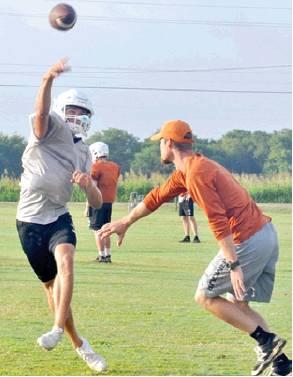 CALDWELL ASSISTANT Coach Scott Ofczarak works with the quarterbacks during this workout. -- Tribune photo by Roy Sanders