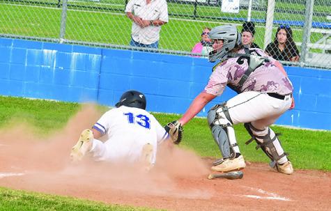 JACOB CASTANEDA slides into home for a score for Snook in an 11-1 win over Mumford. -- Tribune photo by Roy Sanders
