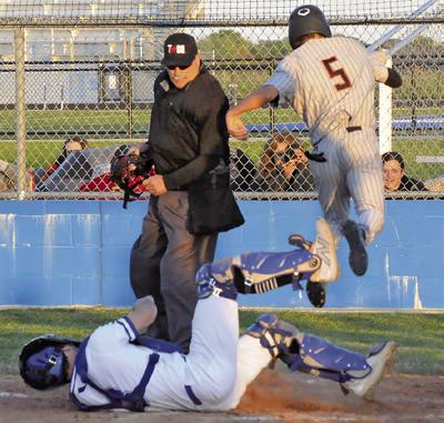SOMERVILLE’SKYLEBROOKS leaps high at home plate to get around Snook catcher Jordan Price. -- Tribune photo by Denise Squier