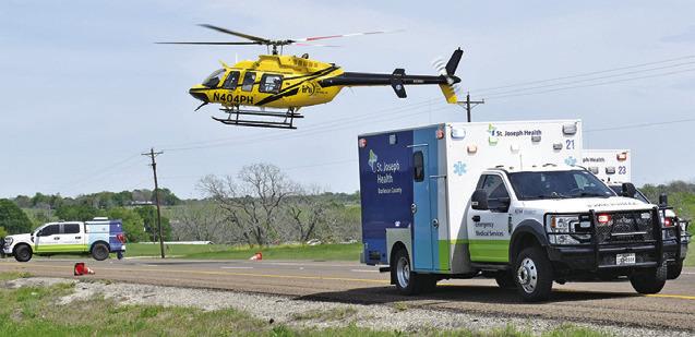 A HELICOPTER LANDS at the scene of the accident on State Highway 21 West.