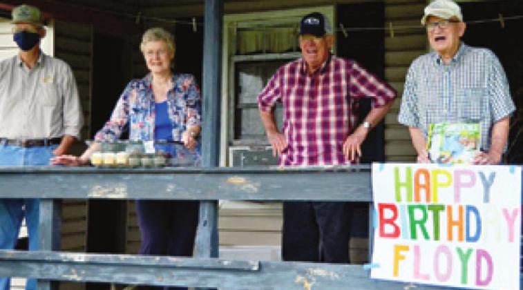 FLOYD WOODS, RIGHT smiles as friends from First United Methodist Church in Somerville honor him with a 90th birthday drive-by celebration at his home off County Road 408.