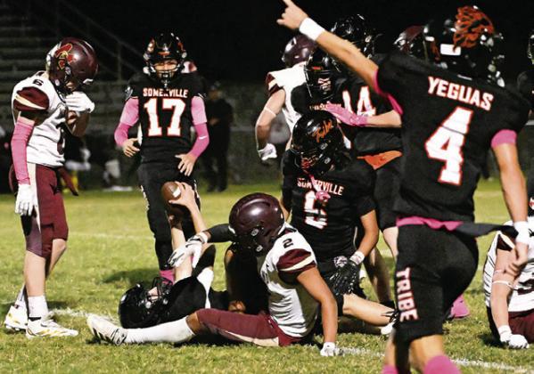 A SOMERVILLE YEGUA recovers a fumble against Milano as teammates look on. They include Landon Discher, Manuel Lucio and Levi Legg. Tribune photo by Denise Squier