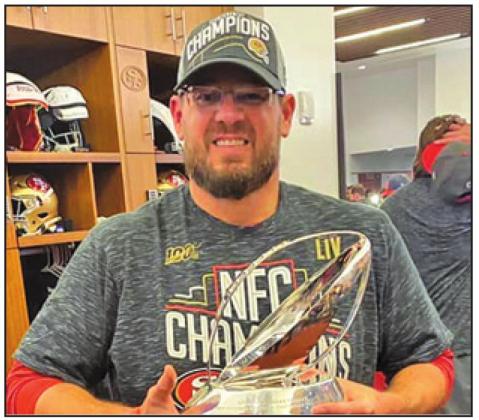KRIS KOCUREK holds the NFC Championship trophy after San Francisco’s 37-20 win last Sunday over the Green Bay Packers.