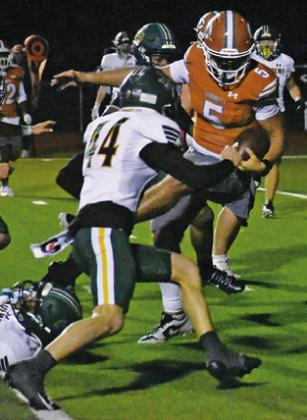 QUARTERBACK JOHN Fryrear fights through these defenders in the Little River Academy game last Friday in Caldwell. Tribune photo by Roy Sanders