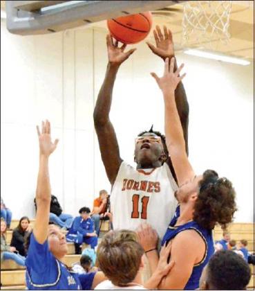 CALDWELL’S BRANDON Williams leaps high for this shot in Caldwell’s 65-48 win over Rockdale. -- Tribune photo by Roy Sanders