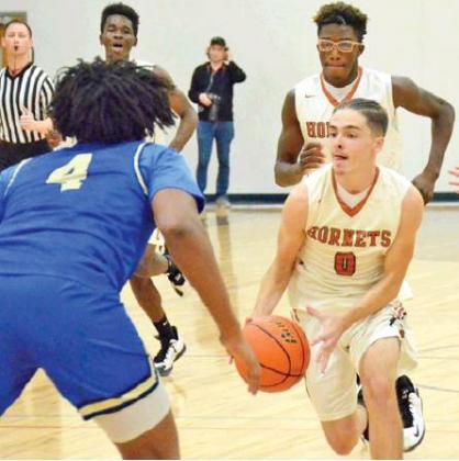 BOBBY LAROUAX dribbles the ball down the court for Caldwell last Friday against Rockdale. The Hornets won their season opener 65-48 in Caldwell. -- Tribune photo by Roy Sanders