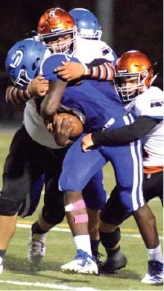 SOMERVILLE’S JESUS ESPINOZA and Philip Haba try to tackle Snook’s Matthew Jordan during Friday night’s Snook-Somerville game at Allen Academy. -- Tribune photo by Denise Hornaday