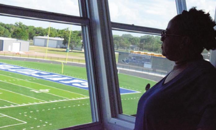 SNOOK SCHOOL BOARD MEMBER Neshae Thomas views Bluejay Stadium from its press box during a walk-through of bond construction projects by the board on Monday. -- Tribune photo by Denise Hornaday
