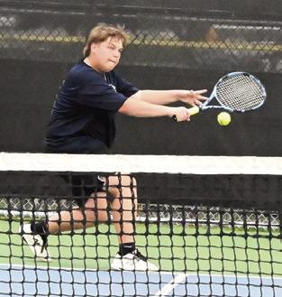 WYATT BEASLEY returns serve during his boys singles match against Franklin’s Jack Stanley last week. Tribune photo by Denise Squier
