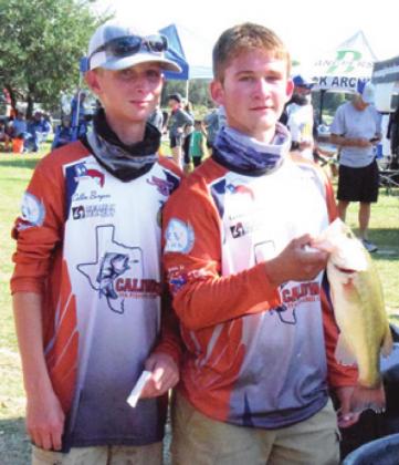 COLLIN BURGESS and Carson Parker hold a fish they caught at a Texas High School Bass Association tournament held at Lake Somerville. -- Tribune photo by Denise Hornaday