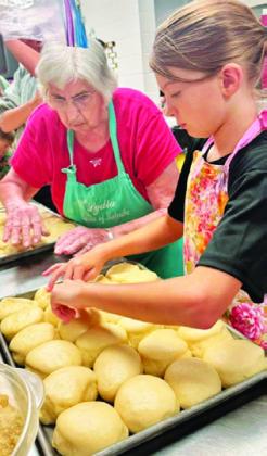 KOLACHE QUEEN Lydia Faust shares her baking knowledge to the next generation of kolache bakers at the annual kolache baking school for the Snook SPJST Youth Club.