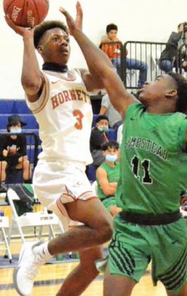 DONTAVIEN JOHNSON jumps to shoot the ball during the Caldwell Hornets’ 62-54 home loss to Hempstead last Friday night.