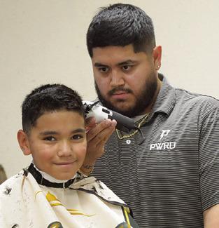 SCHOOL SUPPLIES were not the only things given away at last Wednesday’s “Back to School Blast.” People also received haircuts, diapers and other items for free. Tribune photo by Denise Squier