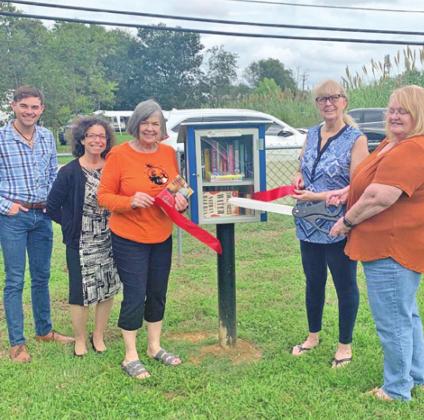 City of Caldwell employees: Forrest Williams, community development director; Heidi Frazier, community development program coordinator; and Creative Memories Quilt Guild members: Vi Griffin; Gayle Whited; and Twana Benner stand by a Little Free Library at a ribbon cutting.