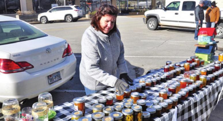ELLEN WELLS OF Just Jammin’ displays her goods on Saturday morning, Jan. 16, at the Farmers Market in downtown Caldwell.