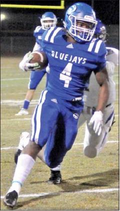 QWAN YOUNG carries the ball for Snook in the Bluejays’ 60-33 victory over the Louise hornets last Friday in Caldwell.