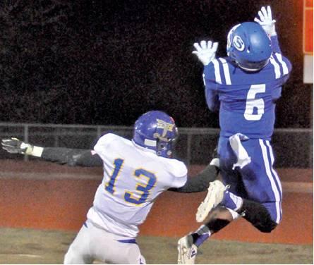 SYDNEY MACK LEAPS high for this pass last Friday against Louise in Caldwell. The Bluejays won 60-33 to secure a playoff spot. They will face Burton on Friday. -- Tribune photo by Roy Sanders