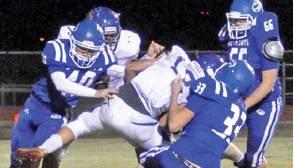 CALEB SEE, DAVID Davis and Seth Groce move in for this tackle last Friday against Louise in Caldwell. The Bluejays won 60--33 to advance to the playoffs. -- Tribune photo by Roy Sanders