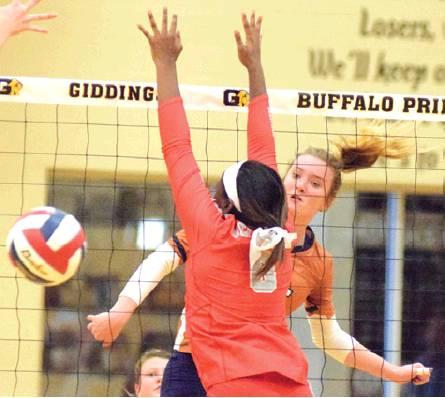 CALDWELL’S ELIZBETH SEE lands one of her 13 kills against Bell-ville on Friday. See was the Lady Hornet leader in kills in the seeding tie-breaker match. -- Tribune photo by Denise Hornaday
