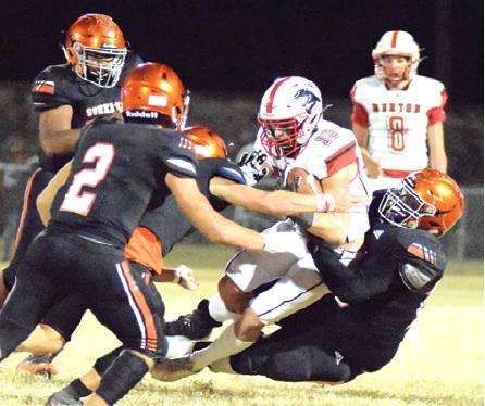 SOMERVILLE’S CEDRIC HUDGEN drags down a Burton player for a tackle. Several other Yeguas ran in to assist Hudgen on the play during Friday night’s game. -- Tribune photo by Denise Hornaday