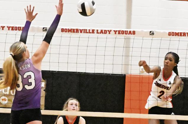 SOMERVILLE’S KARYS ELLIS gets the ball past the outstretched arms of an Aggieland HomeSchool blocker during Somerville’s match against the Lady Panthers last Friday in Somerville. Tribune photo by Denise Squier