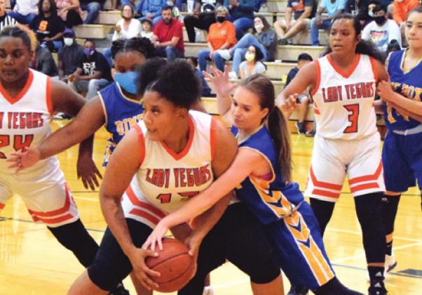SOMERVILLE’S MAR’TASIA WATKINS fights with a Dime Box player to keep posession of the ball for the Lady Yeguas last Tuesday during Somerville’s season opener. -- Tribune photo by Denise Hornaday
