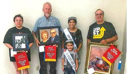 SHANDALA MALDONADO WON grand champion in adult photography-portrait black and white, John Milner won in adult, non-professional oil portrait and Dale Timian won in adult professional acrylic. They are joined by Fair Queen Jessica Enrique and Little Miss Karlee Praesel.