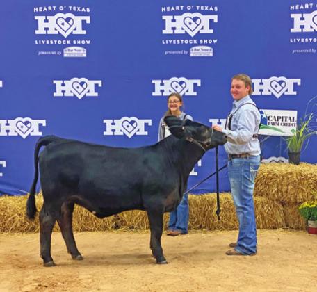 SETH GROCE IS pictured with his fifth place Simbrah Heifer in the American division at the HLSR Calf Scramble Progress Show.