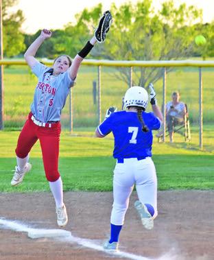 SNOOK’S KALYN COOPER REACHES first base on a wild throw to first during the Snook-Burton game last Friday night. Also pictured is Burton first baseman Melanie Wood. -- Tribune photo by Roy Sanders