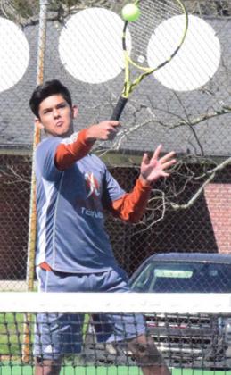 ISAAC SALAZAR backhands the ball at the Rockdale Tiger Classic Tennis Tournament on Friday. -- Tribune photo by Denise Hornaday