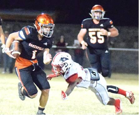 SOMERVILLE’S PHILIP HABA avoids getting tackled by a Burton defender during a quarterback keeper during Friday night’s Somerville-Burton game at The Rock. -- Tribune photo by Denise Hornaday
