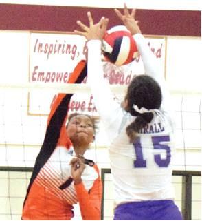 XADRIA MARTIN muscles the ball through the block from Thrall’s Chandra Reed during Monday’s bi-district match in Milano.