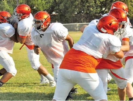 THE SOMERVILLE YEGUAS work on their blocking drills during a recent practice session. Somerville will open its season on Aug. 30 at home against Iola. -- Tribune photo by Roy Sanders