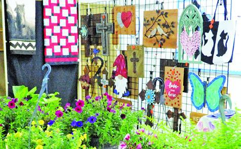 THESE PLANTS AND WALL HANGINGS were on sale during last Saturday’s “Spring Fling Crafts and Plant Sale” held by the Lyons Extension Club. -- Tribune photo by Denise Squier