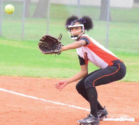 SOMERVILLE’S RA’MAYA CARTER prepares to catch a throw for a forced out at first base during the Lady Yeguas’ win over Iola Monday afternoon during Spring Break. -- Tribune photo by Denise Hornaday