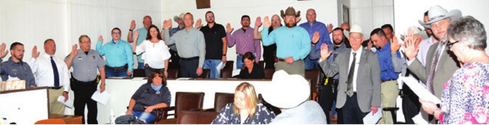 BURLESON COUNTY SHERIFF’S DEPUTIES are sworn into office by County Clerk Anna Schielack on Sunday at the county courthouse. -- Tribune photo by Roy Sanders
