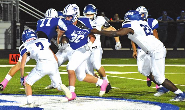 SNOOK’S RYDER BECKA ESCAPES this Bartlett tackler last Friday in the Bluejays’ 56-8 homecoming victory over the Bulldogs. -- Tribune photo by Roy Sanders