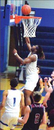 SNOOK’S QWAN YOUNG scores during a Bluejays’ game against Iola in district play. Young was recently named to the TABC Class 2A Region IV Boys All-Region Basketball Team. -- Tribune photo by Denise Hornaday