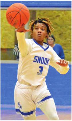 SIDNEY MACK of Snook hurls this pass against Richards on Jan. 14 in Snook. The Bluejays won 68-60 in their last non-district game. -- Tribune photo by Roy Sanders
