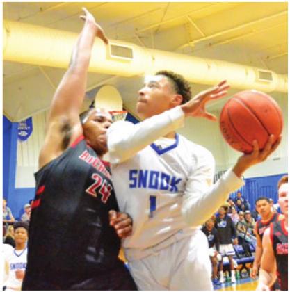 DRERAUD ROGERS takes a shot against Richards on Jan. 14 in Snook. The Bluejays won 68-60. -- Tribune photo by Roy Sanders
