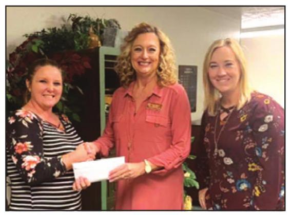MARSHA KOCUREK, right, was selected to be a presenter during the National School Foundation Association’s national conference in Philadelphia, Pa., on March 2-4. She is pictured helping present $2,500 raised from “The Donut Dash for Dyslexia” to Caldwell ISD.