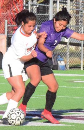 LADY HORNET MIDFIELDER Maria Martinez fights for possession of the ball with a Florence player last Thursday afternoon.