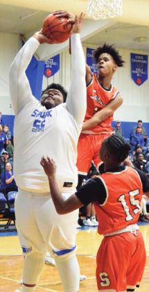 DOMINIC TUCKER blocks a shot by Snook’s James Young during their game last Tuesday night. -- Tribune photo by Denise Hornaday
