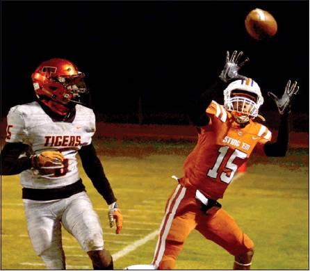 CALDWELL’S LARRY DAVIS reaches for this pass last Friday against Smithville in Caldwell. The Hornets lost 21-2 to conclude their season. Smithville advanced to the playoffs. -- Tribune photo by Roy Sanders