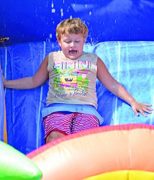 JAMES HUTCHESON enjoys the Harrie P. Woodson Memorial Library’s end of summer water party at J.E. Hejl Park last week.